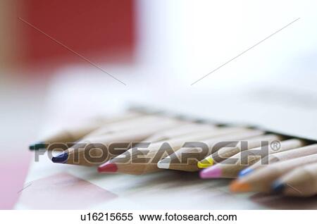Stock Photography - Coloring pencils on book. Fotosearch
