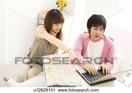 Stock Image - Couple in hospital making travel plans for the future. Fotosearch