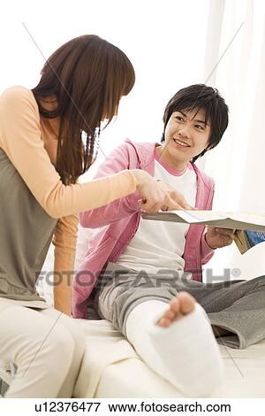 Stock Photo - Couple in hospital making travel plans for the future. Fotosearch