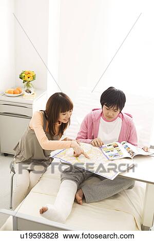 Stock Photo - Couple in hospital making travel plans for the future. Fotosearch
