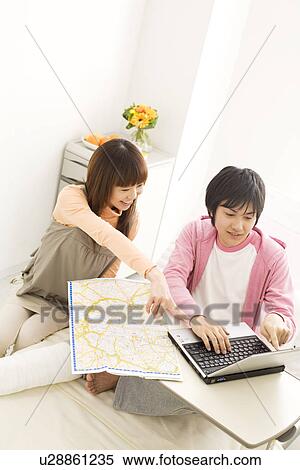 Stock Photography - Couple in hospital making travel plans for the future. Fotosearch
