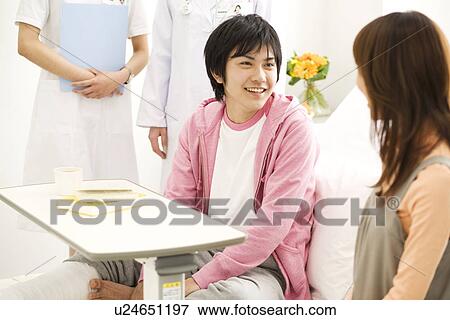 Couple talking in a hospital room View Large Photo Image Stock Photo - Couple talking in a hospital room. Fotosearch