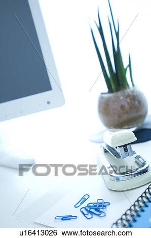 Desk with potted plant, stapler, paper clips and computer View Large Photo Image Stock Photograph - Desk with potted plant, stapler, paper clips and computer. Fotosearch