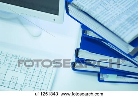 Desktop PC with files stacked next to the monitor View Large Photo Image Stock Image - Desktop PC with files stacked next to the monitor. Fotosearch