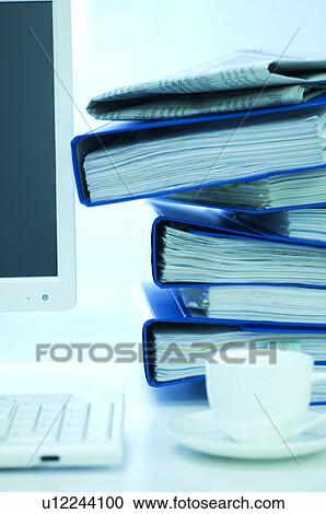 Desktop PC with files stacked next to the monitor View Large Photo Image Stock Image - Desktop PC with files stacked next to the monitor. Fotosearch