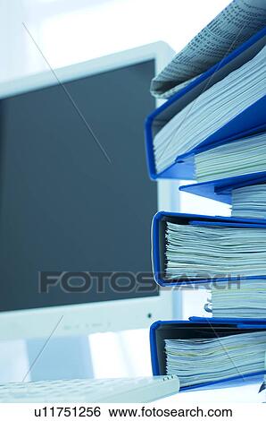 Desktop PC with files stacked next to the monitor View Large Photo Image Stock Photograph - Desktop PC with files stacked next to the monitor. Fotosearch