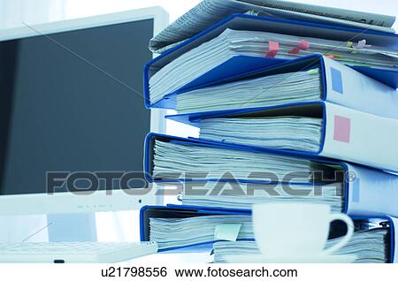 Desktop PC with files stacked next to the monitor View Large Photo Image Stock Photograph - Desktop PC with files stacked next to the monitor. Fotosearch