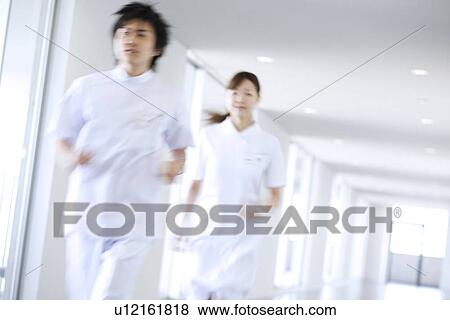 Stock Photo - Doctor and nurse running through hospital. Fotosearch