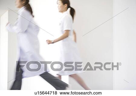Stock Photo - Doctor and nurse running through hospital. Fotosearch