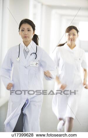 Stock Photo - Doctor and nurse running through hospital. Fotosearch