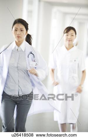 Doctor and nurse running through hospital View Large Photo Image Stock Photo - Doctor and nurse running through hospital. Fotosearch