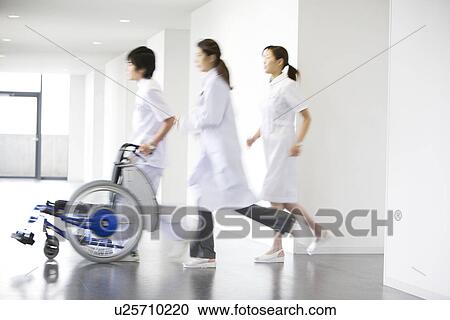 Doctor and nurses running through hospital View Large Photo Image Stock Image - Doctor and nurses running through hospital. Fotosearch