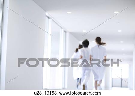 Stock Photo - Doctor and nurses running through hospital. Fotosearch