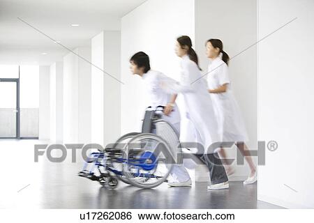 Doctor and nurses running through hospital View Large Photo Image Stock Photograph - Doctor and nurses running through hospital. Fotosearch