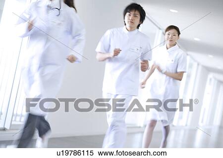 Stock Photography - Doctor and nurses running through hospital. Fotosearch