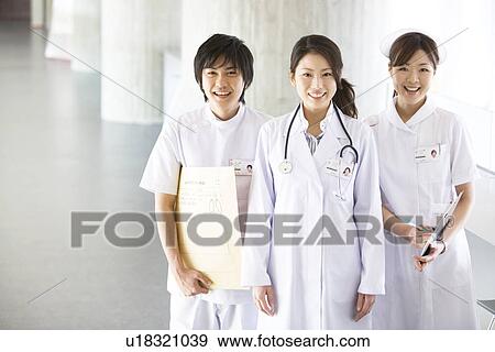 Stock Photo - Doctor, nurse and an x-ray technician smiling at the camera. Fotosearch
