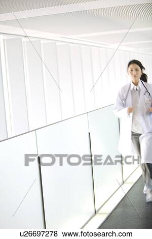 Stock Photo - Doctor running with chart through hallway. Fotosearch