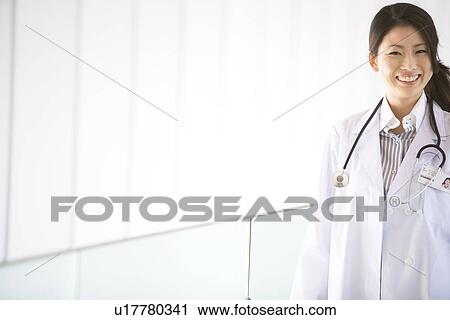 Stock Image - Doctor smiling at the camera. Fotosearch