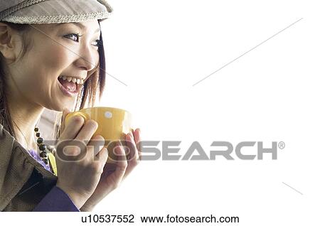 Stock Image - Fashionable woman drinking coffee. Fotosearch