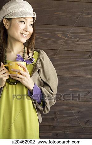 Stock Image - Fashionable woman drinking coffee. Fotosearch