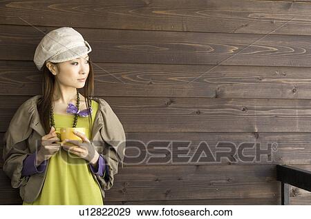 Stock Photo - Fashionable woman drinking coffee. Fotosearch