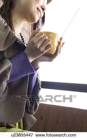 Stock Photo - Fashionable woman drinking coffee. Fotosearch