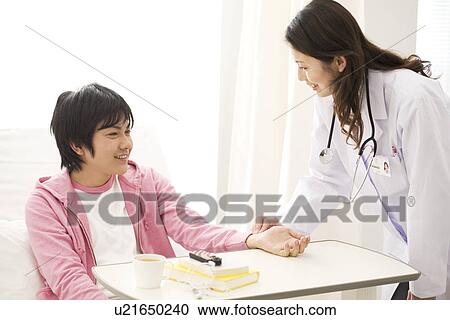 Female doctor taking a man's pulse View Large Photo Image Stock Image - Female doctor taking a man's pulse. Fotosearch