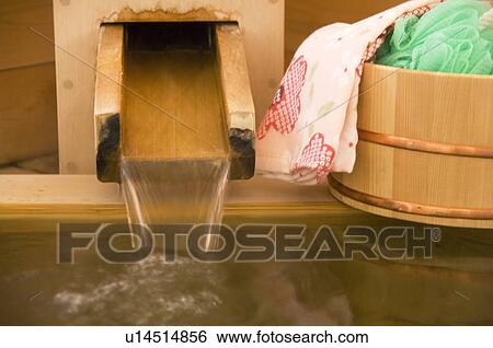 Stock Photograph - Flowing water from a spout at a health spa. Fotosearch