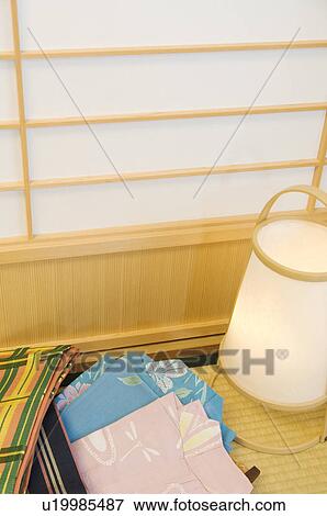 Folded yukata next to a lantern in a Japanese room View Large Photo Image Stock Photo - Folded yukata next to a lantern in a Japanese room. Fotosearch