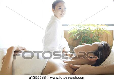 Picture - Friends take turns receiving massages. Fotosearch