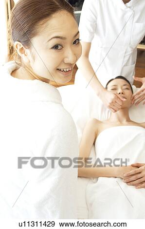 Stock Photo - Friends take turns receiving massages. Fotosearch