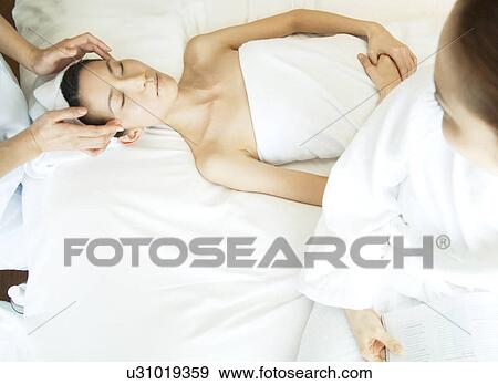 Stock Photo - Friends take turns receiving massages. Fotosearch