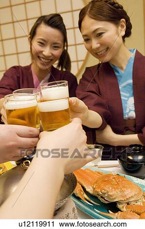 Friends toasting with glasses of beer View Large Photo Image Stock Image - Friends toasting with glasses of beer. Fotosearch