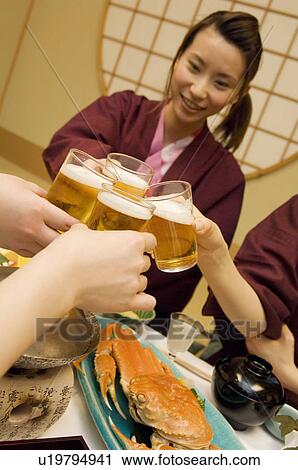 Friends toasting with glasses of beer View Large Photo Image Stock Image - Friends toasting with glasses of beer. Fotosearch