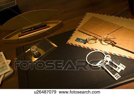 Glasses, air mail and keys on desk View Large Photo Image Stock Photo - Glasses, air mail and keys on desk. Fotosearch