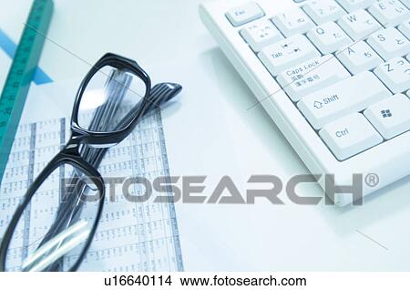 Picture - Glasses, data, ruler and a keyboard. Fotosearch