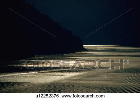 Stock Photograph - Illuminated water at twilight. Fotosearch