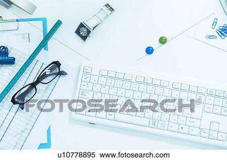 Keyboard and glasses on desk with documents, ruler and watch View Large Photo Image Stock Photography - Keyboard and glasses on desk with documents, ruler and watch. Fotosearch