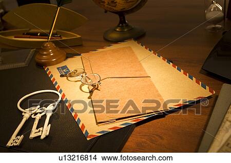 Picture - Keys and air mail on desk. Fotosearch