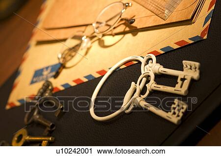 Stock Image - Keys and air mail on desk. Fotosearch