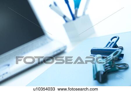 Laptop and files with binder clips on desk View Large Photo Image Stock Image - Laptop and files with binder clips on desk. Fotosearch