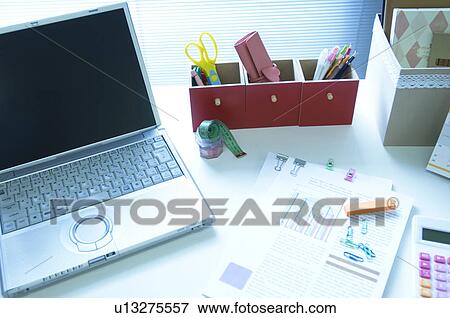 Laptop on desk with files View Large Photo Image Stock Photo - Laptop on desk with files. Fotosearch