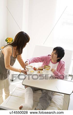 Stock Photo - Man having a meal in his hospital bed. Fotosearch