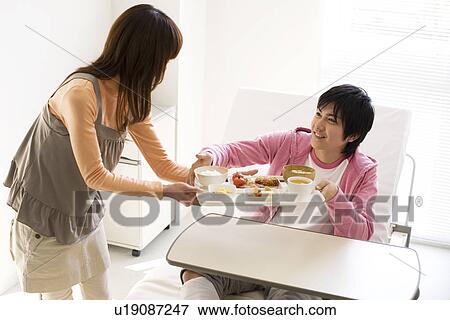 Man having a meal in his hospital bed View Large Photo Image Stock Photo - Man having a meal in his hospital bed. Fotosearch