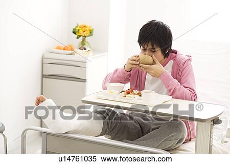 Stock Photography - Man having a meal in his hospital bed. Fotosearch