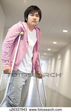Stock Image - Man on crutches in the hospital. Fotosearch