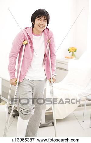 Stock Photo - Man on crutches in the hospital. Fotosearch