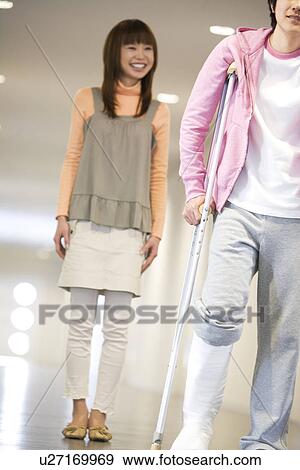 Man on crutches in the hospital View Large Photo Image Stock Photo - Man on crutches in the hospital. Fotosearch