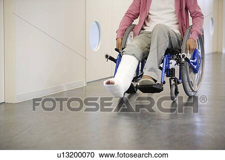Man with broken leg in a wheelchair View Large Photo Image Stock Image - Man with broken leg in a wheelchair. Fotosearch