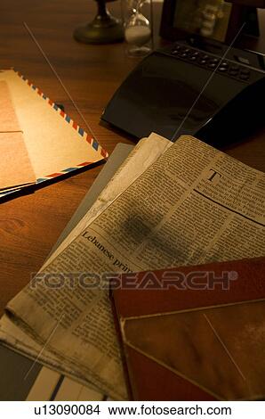 Newspaper and old book on desk View Large Photo Image Picture - Newspaper and old book on desk. Fotosearch